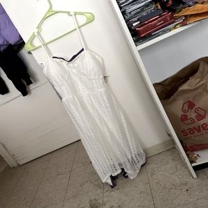 White sun dress with sparkly purple trim on the bust and hem